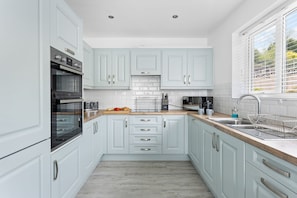 Enjoy cooking in this well-equipped kitchen with an oven, coffee maker, and toaster.