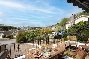 Enjoy a meal on the balcony with a view of the surrounding neighborhood.