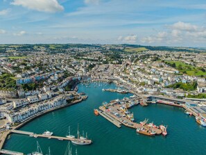 Stunning coastal town with a vibrant harbor, marina, and picturesque bridge.