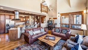 A spacious living area with a kitchen, a dining area, and a loft bedroom. - BIG downtown home w/ views and great amenities! (Breckenridge)
