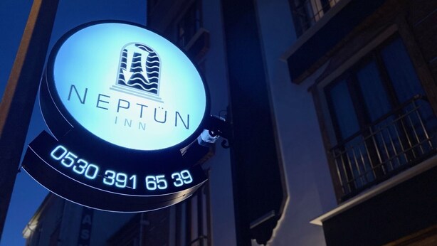 A neon sign for Neptune Inn with a phone number. - NEPTÜN INN (Kirklareli)