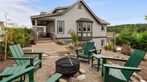 A house with a covered porch, outdoor seating, and a fire pit. - Seabrook Hidden Treasure | Pirate Theme, Hot Tub | 4BR, Sleeps 11, EV Charger (Pacific Beach)