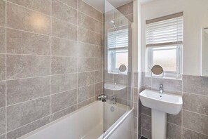 Bathtub, hair dryer, towels, soap