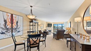 A spacious living room with a dining area, a fireplace, and a large mirror. - Closely located to Seascape Golf Course & Seascape Village (Aptos)