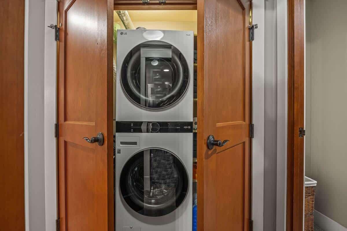 A laundry room with two stacked washing machines.