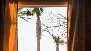 A balcony with wicker furniture and a view of the ocean.