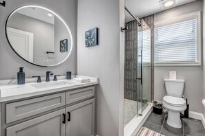 Bathtub, hair dryer, towels, shampoo
