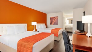 A hotel room with two beds, a desk, a chair, a TV, and a bathroom visible in the background. - 3 minutes to Cozy one Bedroom in Lookout Mountain  (Chattanooga)