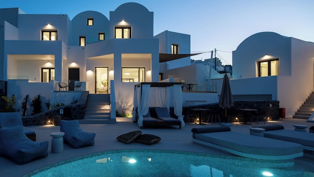 A modern villa with a swimming pool, outdoor seating, and a staircase leading to the upper levels. - CUORE SANTO SUITES  (Santorini)