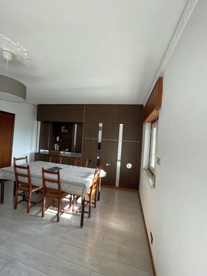Enjoy meals with family and friends in this dining area, featuring a large table and comfortable seating for six.