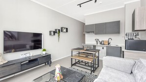 Classic Apartment | Living area | 50-inch flat-screen TV with cable channels, TV, streaming services - The Bailey 61A (Sandton)