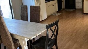 A compact kitchen with a dining area, including a table and chairs. - Lake house with access to the best beach for swimming & fishing on Lake Hamilton (Hot Springs)