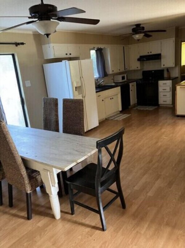 A compact kitchen with a dining area, including a table and chairs.