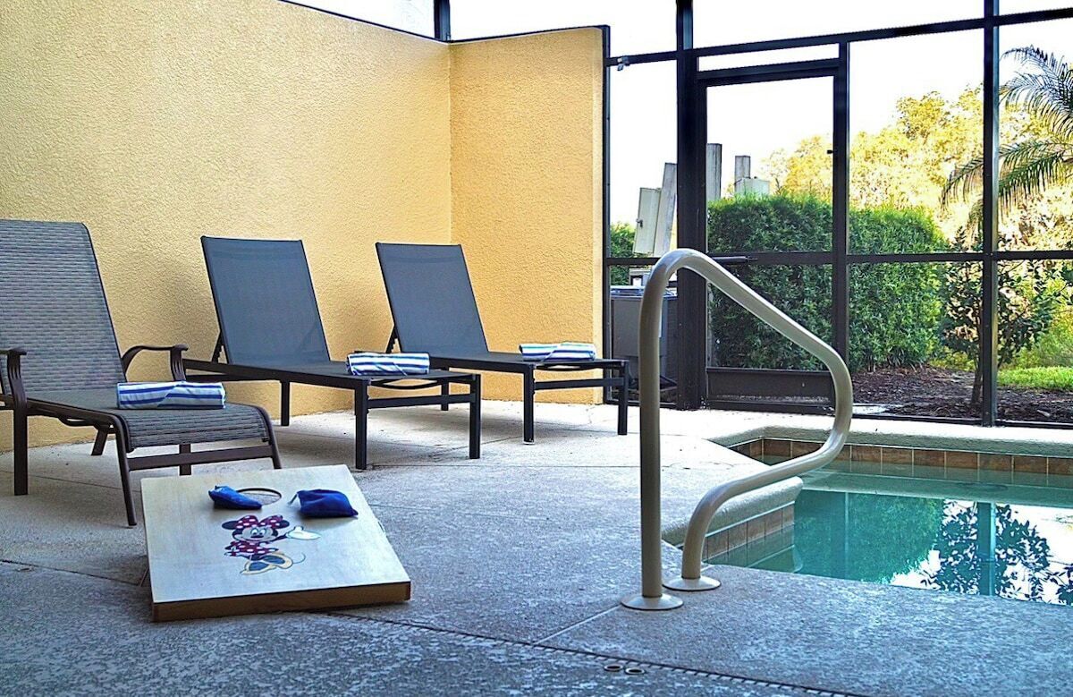 A poolside area with lounge chairs and a pool.