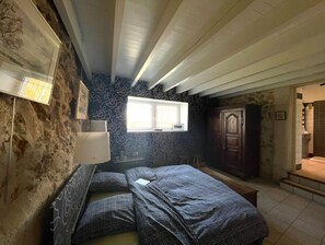 Cozy retreat with a single bed, bedside table, and wooden wardrobe.