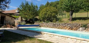 Relax by the pool surrounded by lush gardens and a serene atmosphere.