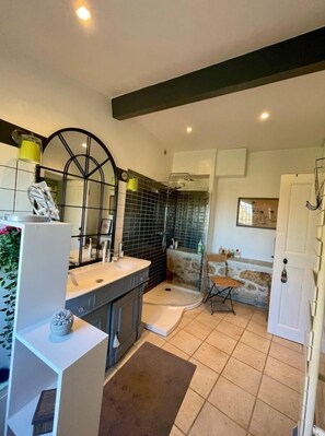Bathroom features a shower with a glass door, a sink with a mirror, and a comfortable rug.