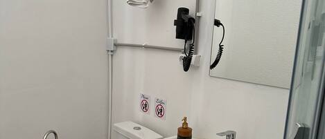 A bathroom with a toilet, sink, and towel rack.