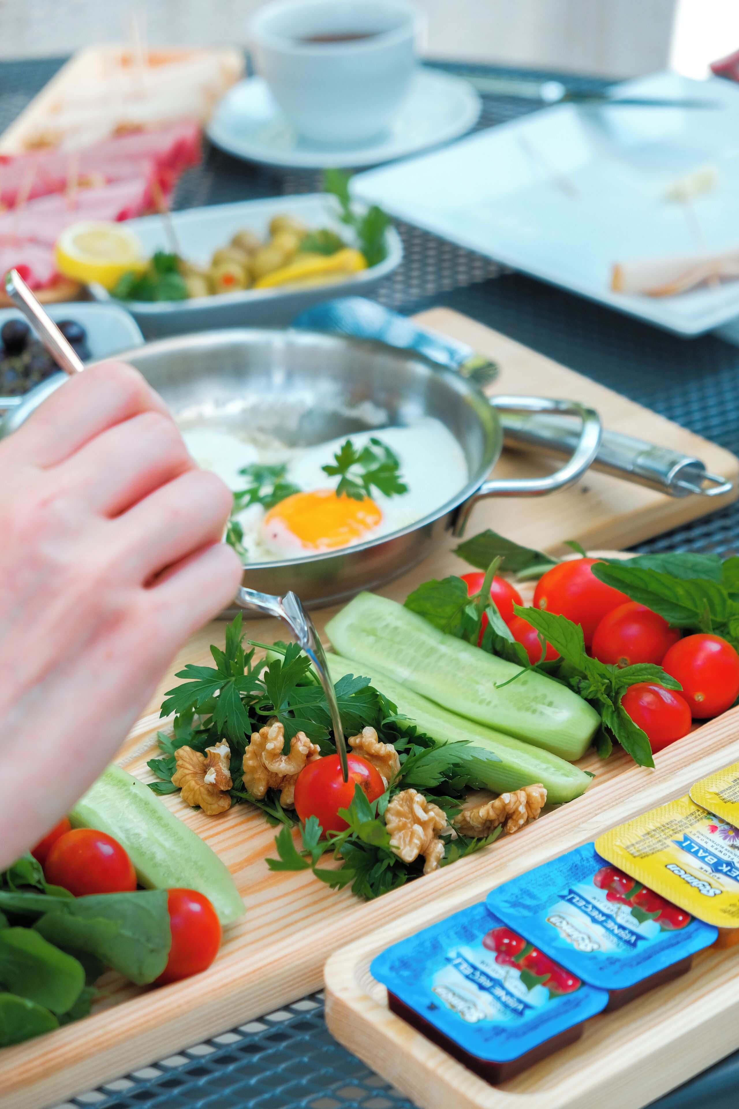 A breakfast tray with eggs, vegetables, and condiments.