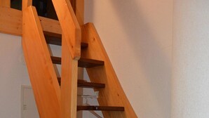 A wooden staircase with a handrail and multiple steps. - Topas 24 by Interhome (Saas-Fee)