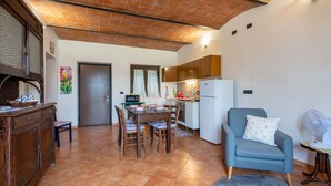 A compact living space with a dining area, kitchenette, and seating area. - Casa dei Nonni by Interhome (Calliano)