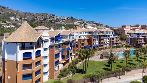 A coastal resort with multi-story buildings, a swimming pool, and a hillside backdrop. - Mirador Galera Playa Free Padel by Interhome (Almuñécar)