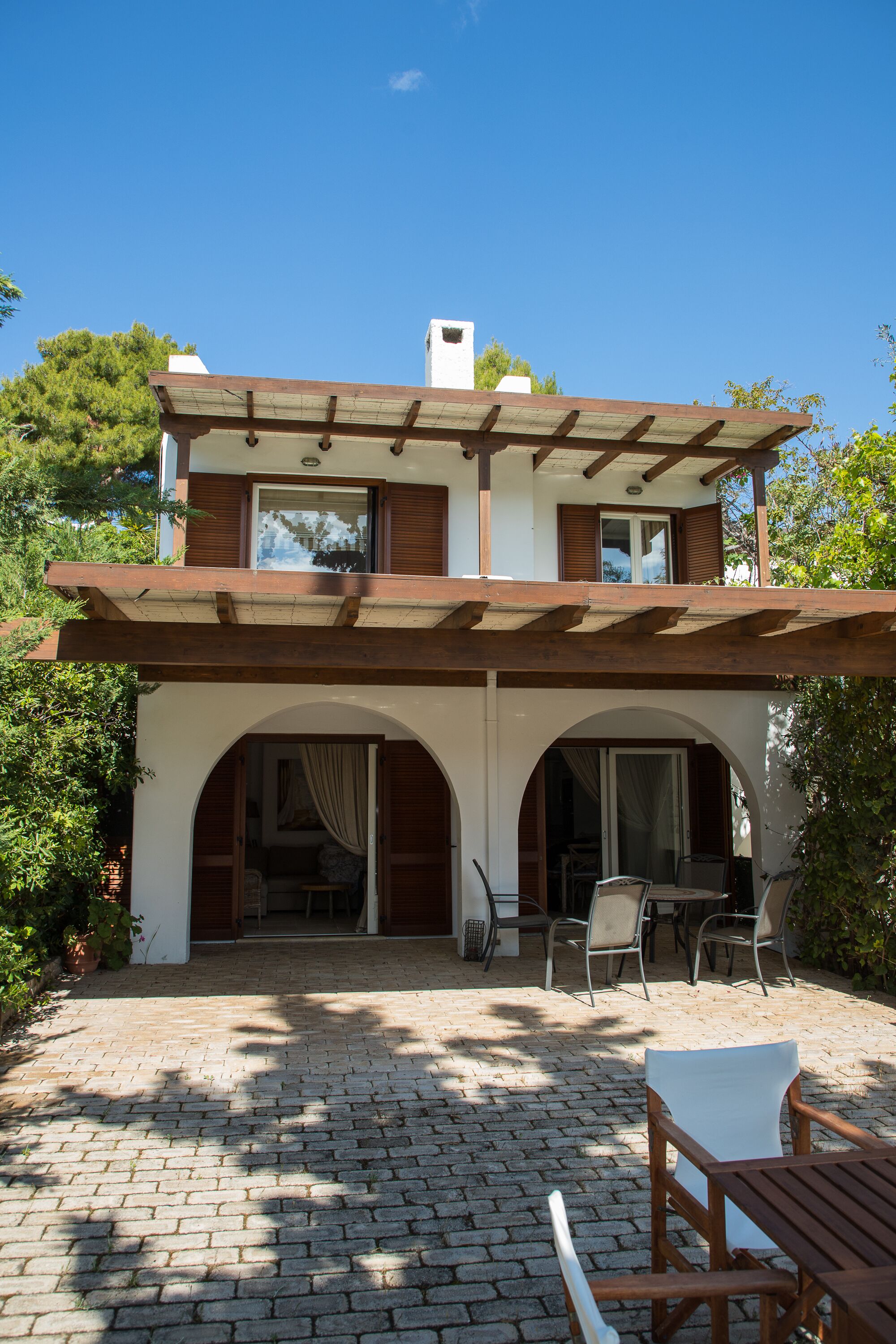 A two-story house with a patio area.