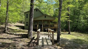 A lodge with a wooden deck and a sign reading "WOOD HAVEN" in a forested area. - Park and ride to the ATV trailhead and the Mulberry River at Cass Arkansas. (Ozark)