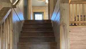 A wooden staircase leading to a room with a window and a ceiling fan. - Park and ride to the ATV trailhead and the Mulberry River at Cass Arkansas. (Ozark)