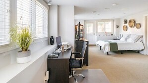 A modern bedroom with a desk, chair, and a bed. - Red Fox Run Hideaway (Victor)