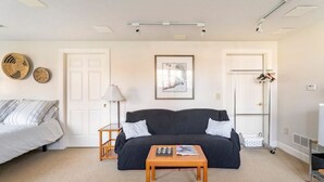 A living room with a sofa, a coffee table, a lamp, and a framed picture on the wall. - Red Fox Run Hideaway (Victor)
