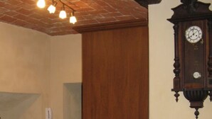 A room with a wooden chair, a wall clock, and a radiator. - 2 Bedroom Bed & breakfast in Condove (Condove)