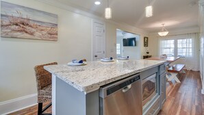 A modern kitchen with a granite countertop, stainless steel appliances, and pendant lighting. - Walk to Water: Coastal-Chic Home Near Myrtle Beach (Atlantic Beach)