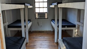 A room with bunk beds, a window, and a wooden floor. -  Come enjoy the Ocoee River and all its beautiful nature with us! (Benton)