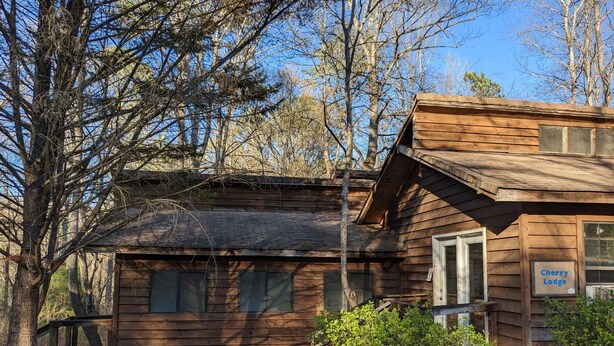 A rustic wooden cabin with a sign reading "Cherry Lodge." -  Come enjoy the Ocoee River and all its beautiful nature with us! (Benton)
