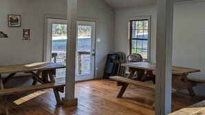 A room with wooden flooring, two windows, and a ceiling fan. -  Come enjoy the Ocoee River and all its beautiful nature with us! (Benton)