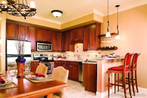 Enjoy meals at the central island with sink and bar seating, or dine at the table for two.