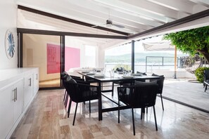 Enjoy meals with family and friends in this spacious dining area, featuring a large table and comfortable seating for four.