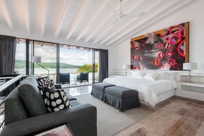 Relax in a serene room with a large bed, scenic views, and a cozy seating area.