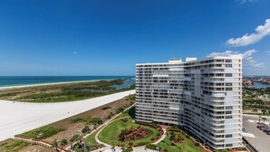 A high-rise hotel with multiple balconies, a landscaped garden, and a view of the beach and ocean. - Views of Tigertail Beach and sunsets (Marco Island)
