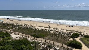 A beach with a wooden fence, sandy dunes, and the ocean. - OCEANFRONT with Balcony, Updated Condo; Gorgeous views; sleeps 6 (Ocean City)