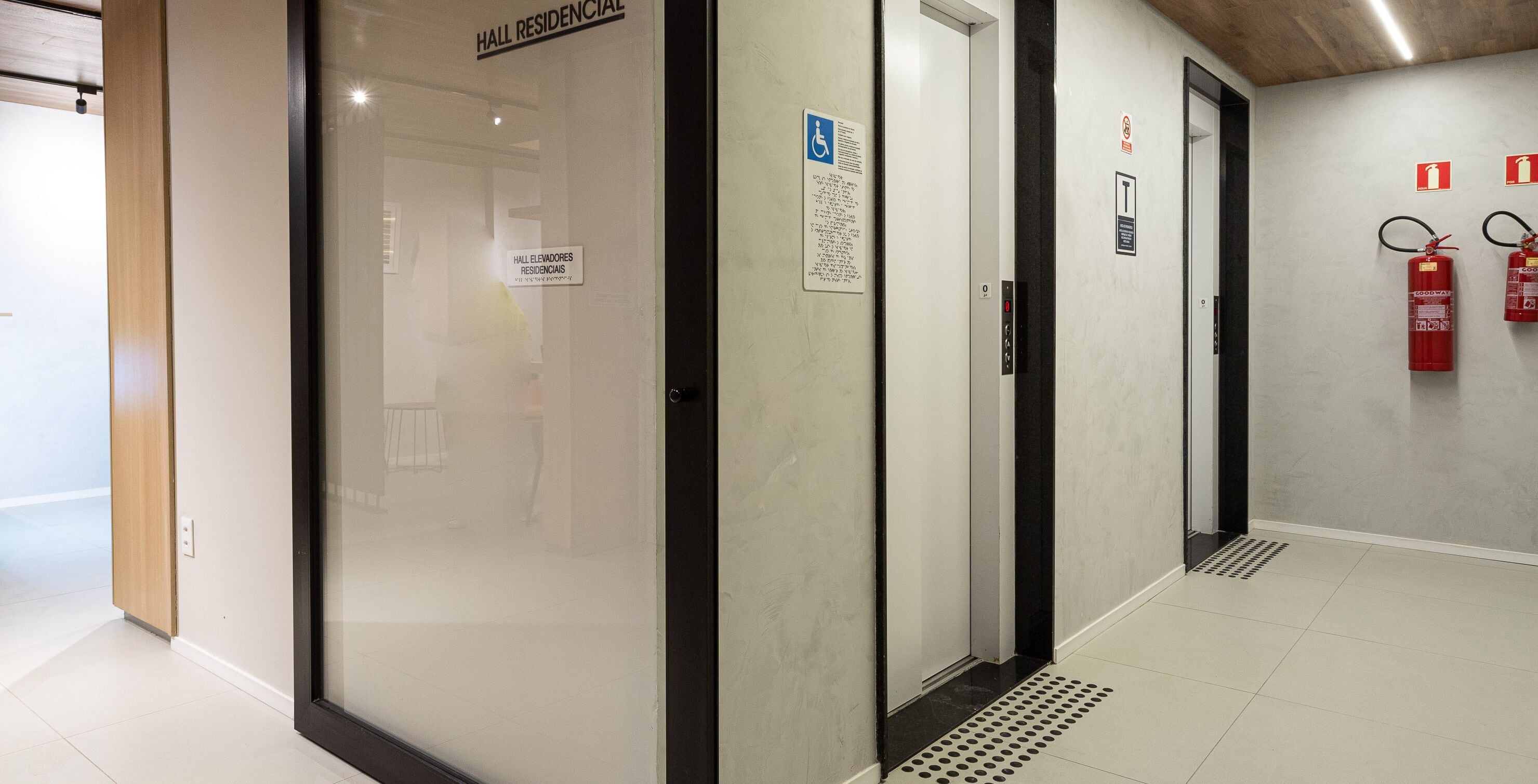 Un espace d’ascenseur avec des panneaux indiquant qu’il est réservé aux résidents et accessible aux personnes handicapées.