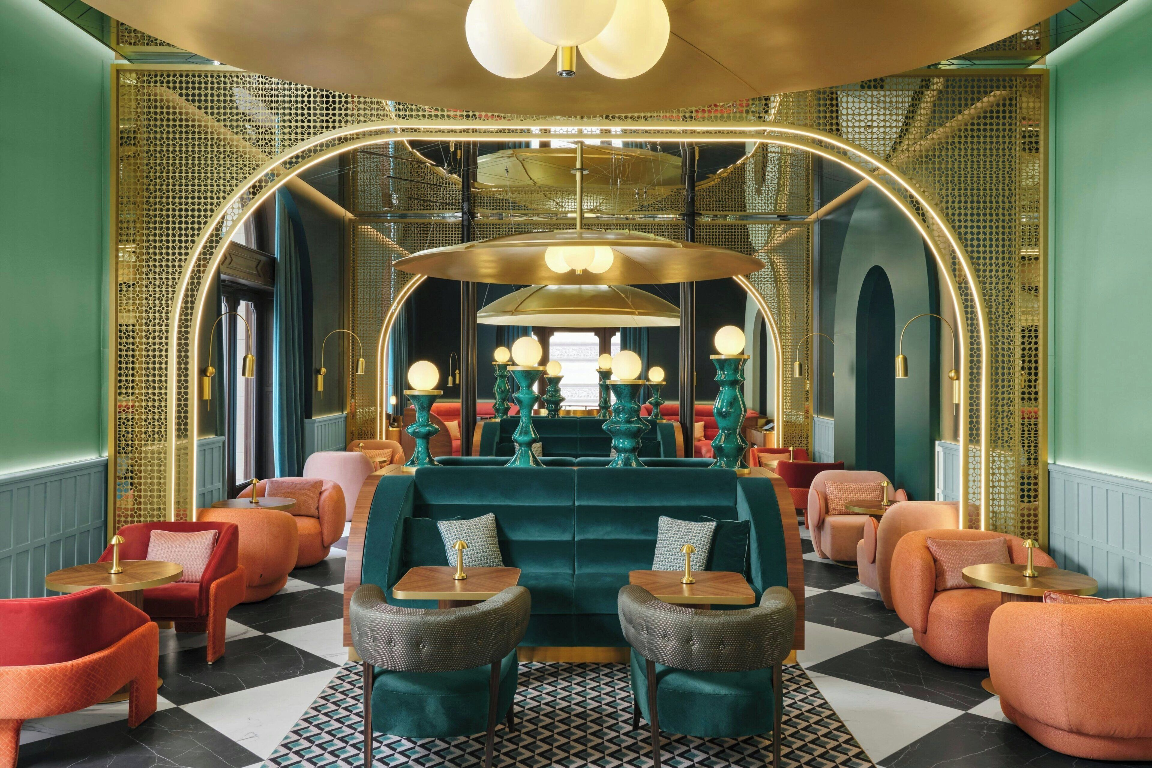 A luxurious lounge area with plush seating, a central sofa, and a patterned floor.