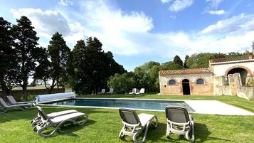 Seasonal outdoor pool, open 9:00 AM to 7:00 PM, pool umbrellas