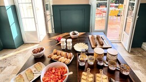 A breakfast buffet with various foods and condiments.