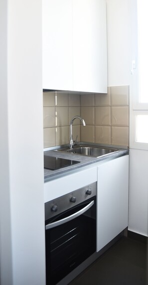Enjoy cooking in this well-equipped kitchen with a stainless steel sink and oven.
