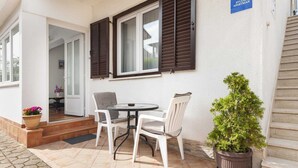 A small patio with a round table and two chairs, a potted plant, and a sign reading "STUDIO APARTMAN". - MAXI One-Bedroom Apartment 2 (Rovinj)