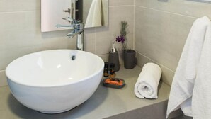 A modern bathroom with a large white sink, a mirror, and a window. - Falasarna Seafront House I 50 m to the Beach (Kissamos)