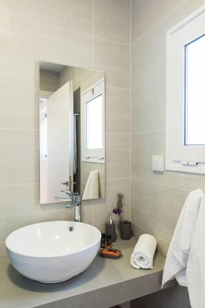A modern bathroom with a large white sink, a mirror, and a window. - Falasarna Seafront House I 50 m to the Beach (Kissamos)