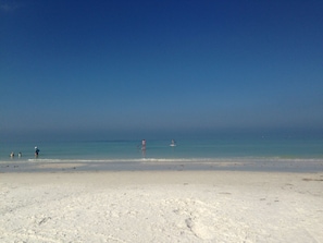 A beach with a clear sky and calm sea. - Gorgeous 2 Bed 2 Bath Gulf front, just steps to the white powder beach (Siesta Key)